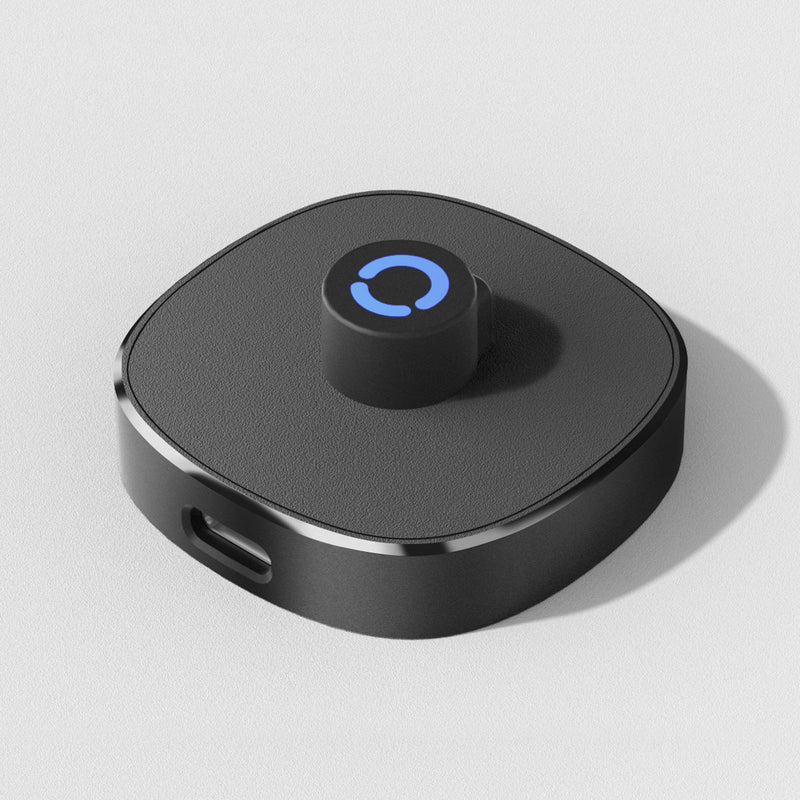 Black smart ring charging dock with blue indicator light. Effortless magnetic charging for sleep tracking ring.