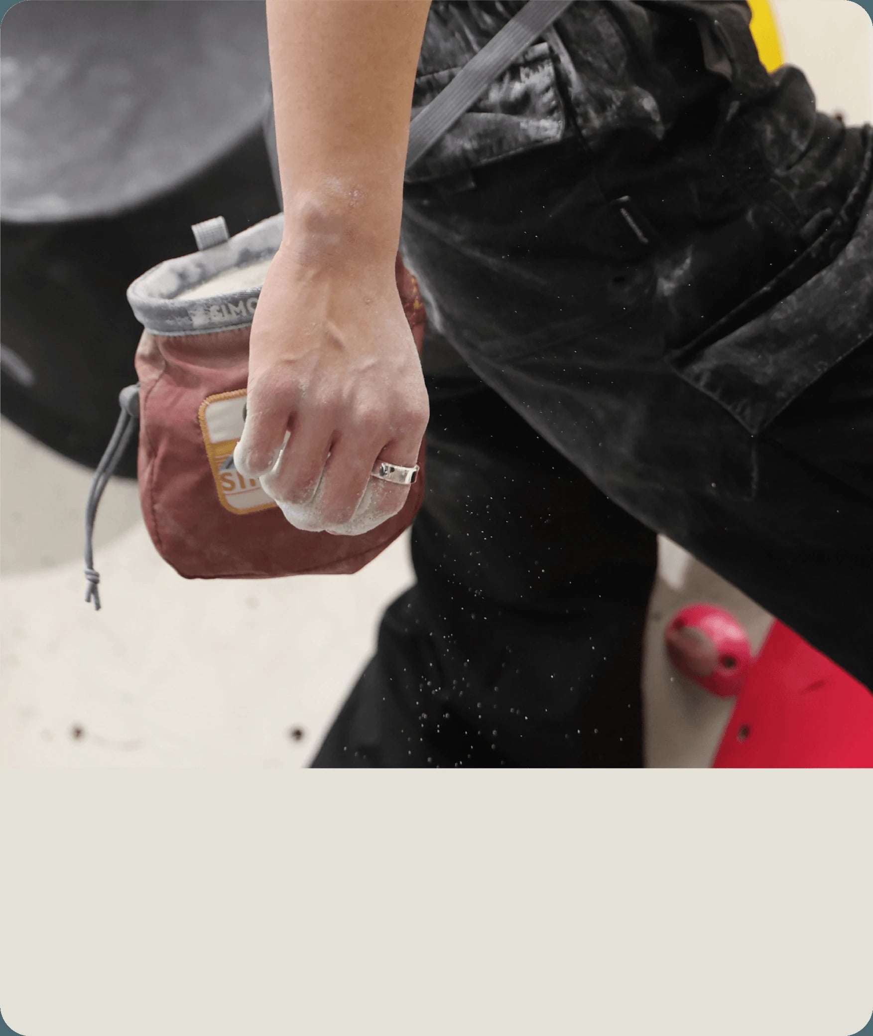 Silver smart ring on hand with chalk bag. Active lifestyle, health tracking wearable