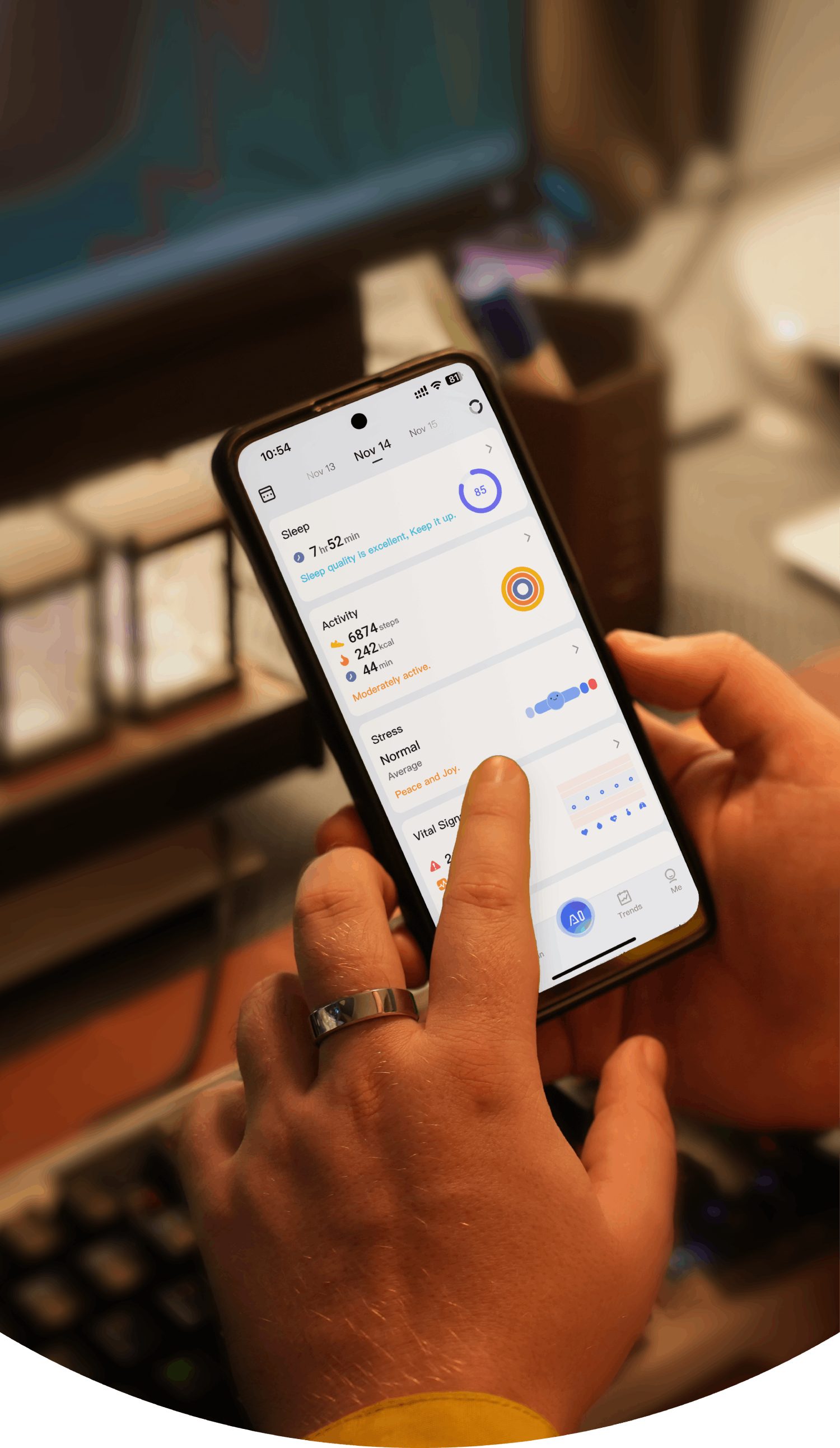 Smart ring user checking health data on smartphone, showing sleep, activity, and stress metrics.